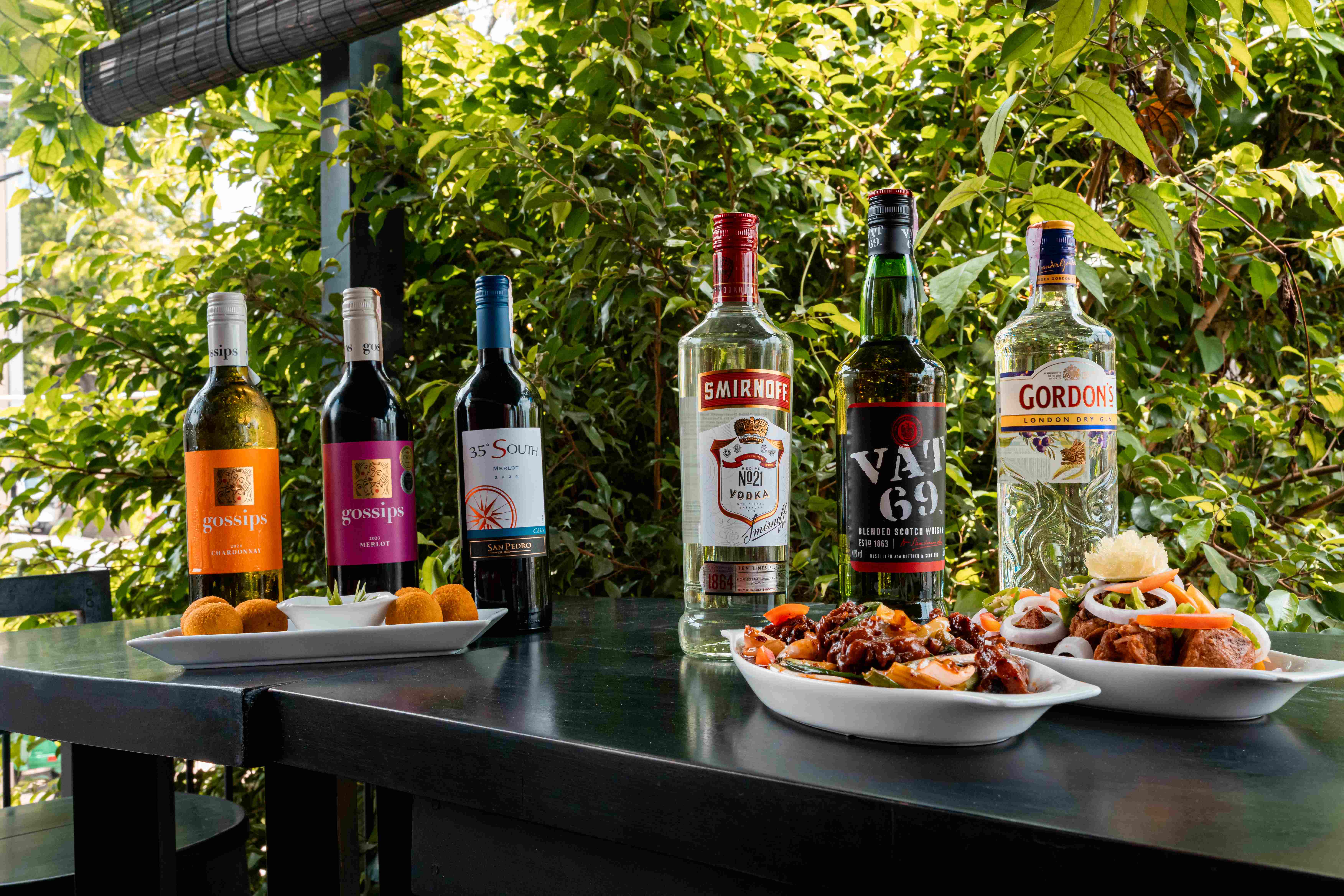 Chopsticks dishes and drinks on a terrace table